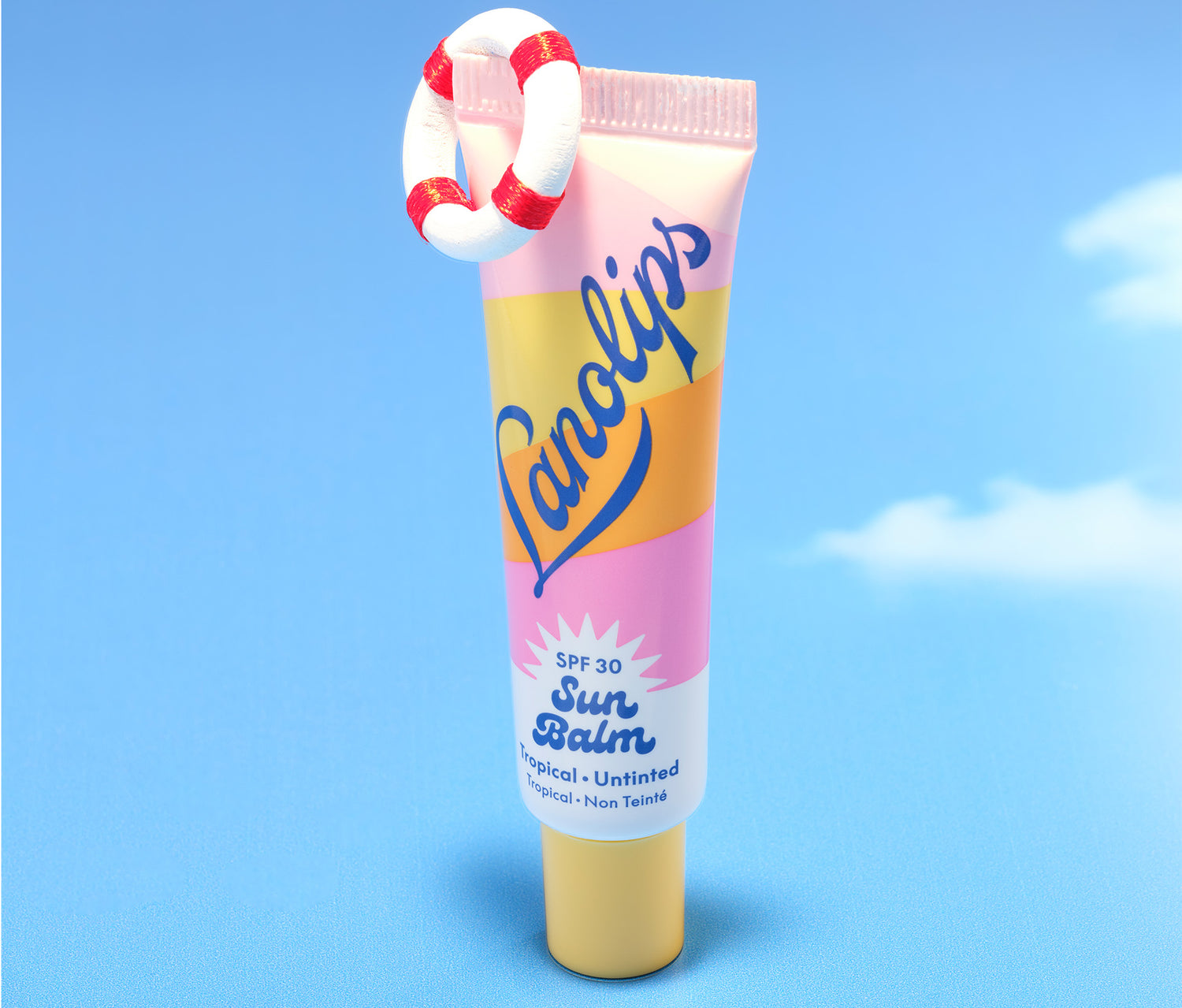 Lanolips Sun Balm SPF 30 Tropical lip balm stands upright against a blue sky, adorned with a mini lifebuoy - bright, bold, and ready for summer lips.Lanolips Sun Balm SPF 30 Tropical lip balm stands upright against a blue sky, adorned with a mini lifebuoy - bright, bold, and ready for summer lips.