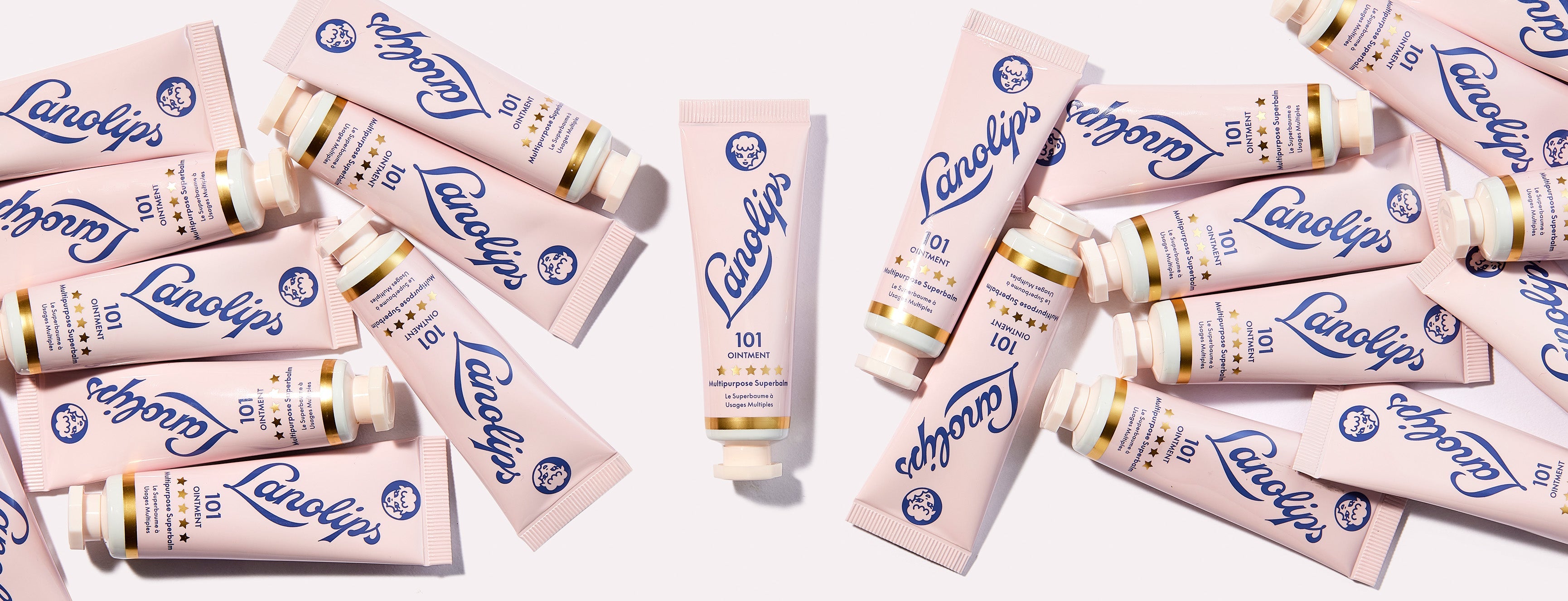 A flatlay of multiple Lanolips The Original 101 Ointment Multipurpose Superbalm surrounding one upright tube. Made with ultra-pure grade lanolin, this cult-favourite, multi-award winning balm has been voted "The World's Best."
