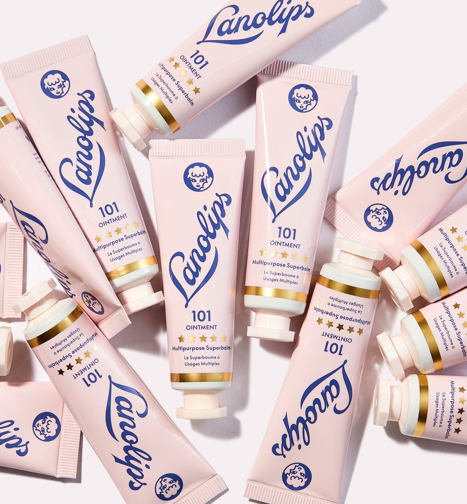 A flat lay of Lanolips Original 101 Ointment Multipurpose Superbalm tubes, the cult-favourite multipurpose balm made with ultra-pure lanolin. Shown on the Contact Us page to reflect the Lanolips' hero product, known for delivering intense hydration for dry lips, skin patches, cuticles, and more. Multi-award-winning and beloved globally for its natural, powerful formula.