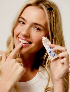 Model holding the 101 Ointment Original Multipurpose Superbalm.