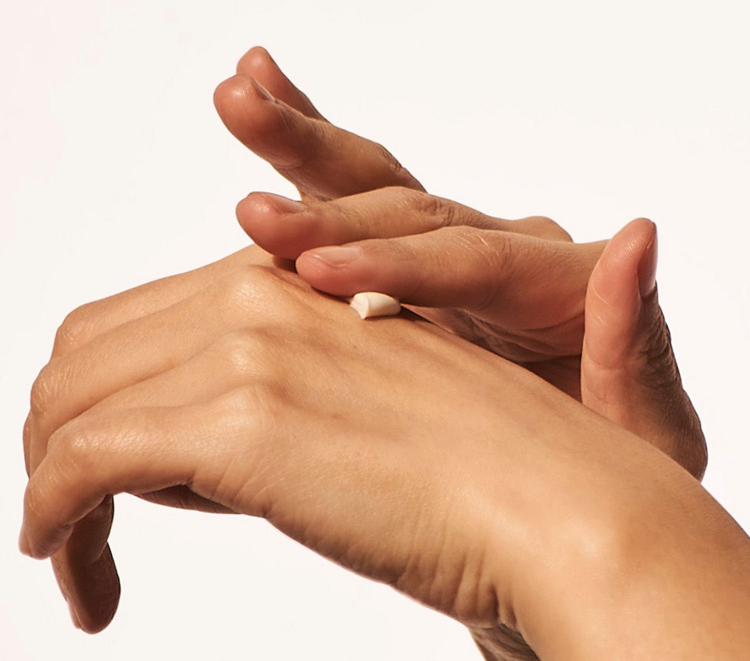 Close up of hands applying a rich, nourishing cLanolips Hand Cream Intense collection. Formulated with triple lanolin, this ultra-hydrating hand cream locks in moisture and repairs dry, rough skin. Available in four indulgent options—Coconutter, Rose, Milk & Honey, and Vanilla—it deeply conditions while leaving a soft, silky finish. Perfect for daily hydration, this dermatologically tested formula provides intense nourishment for even the driest hands.