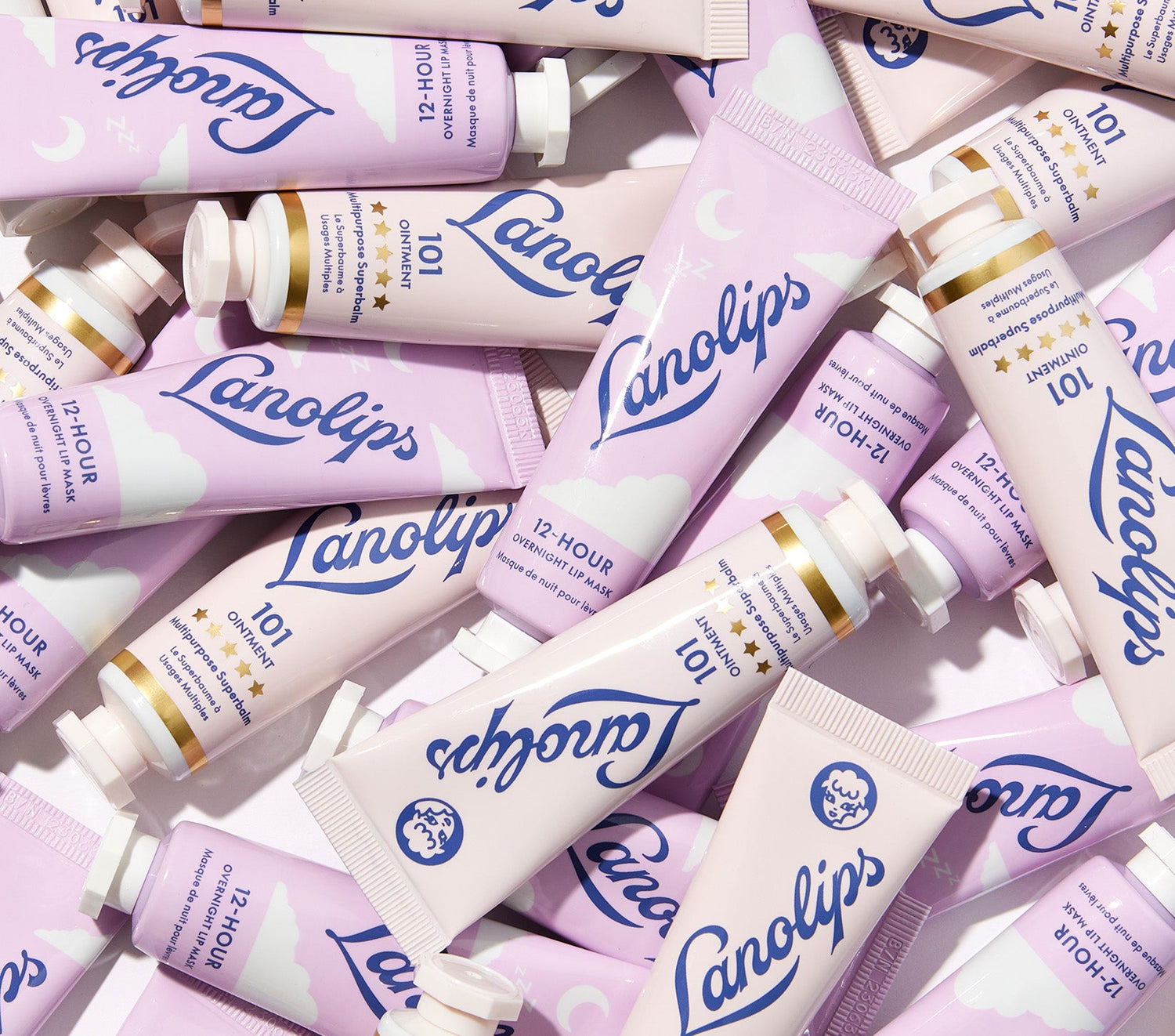 Flat lay of Lanolips Lip Heroes Day & Night Duo featuring pastel pink and purple tubes of 101 Ointment Multipurpose Superbalm and 12 Hour Overnight Lip Mask. The 101 Ointment, voted ‘The World’s Best Lip Balm’ by Reddit, deeply hydrates and protects dry lips, skin, cuticles, and more. The Overnight Lip Mask is enriched with lanolin, vitamin C, vitamin E, hyaluronic acid, and honey to nourish and repair while you sleep. A perfect lip care duo for long-lasting hydration, day and night.