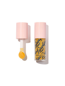 Product shot of the Lanolips Hyaluronic Lip Oil in Honey, featuring the open bottle with its yellow applicator wand displayed. The lip oil contains lanolin, hyaluronic acid, and vitamin E for deep hydration, nourishment, and a glossy finish