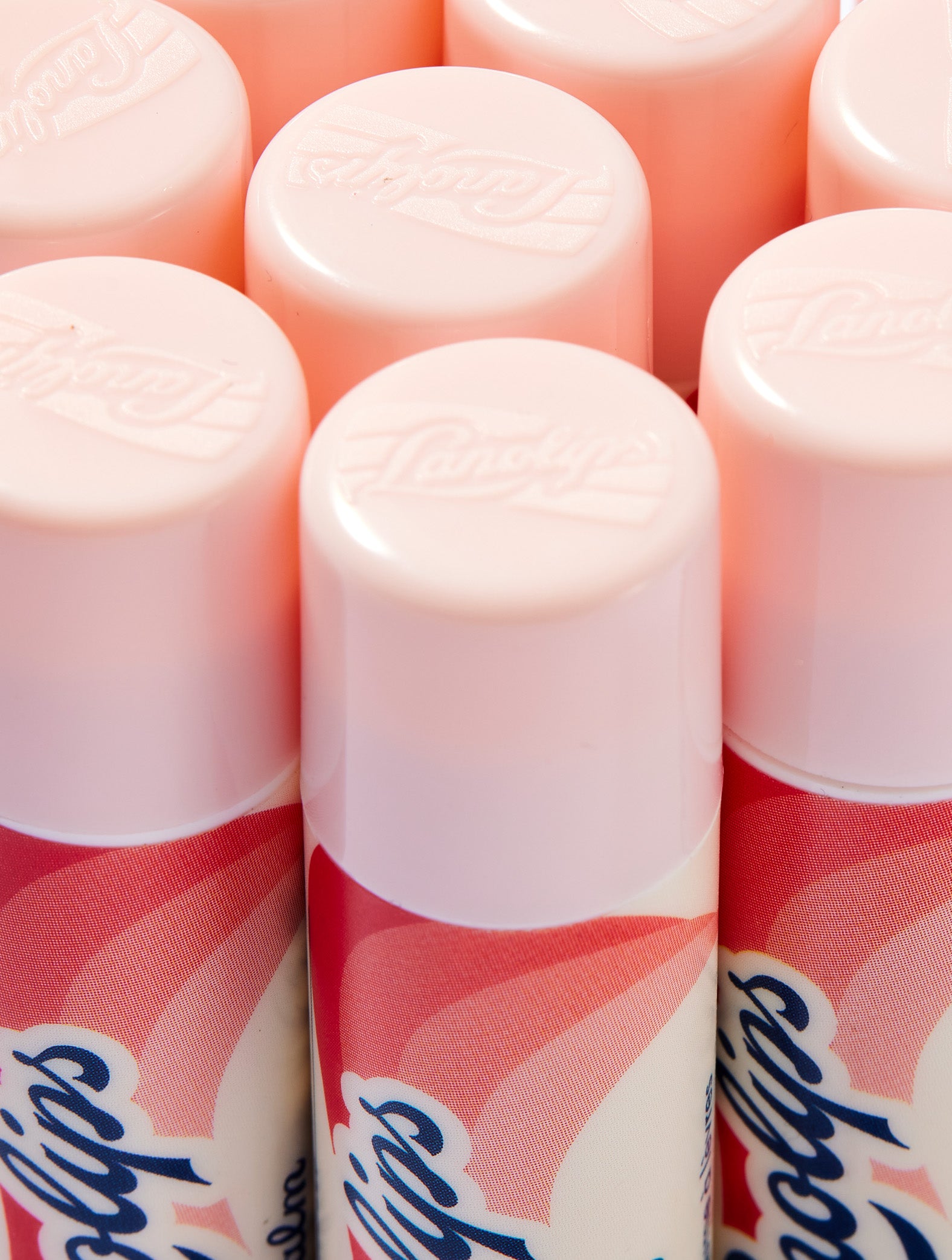 Close-up shot of the Lanolips Basic Balm Strawberry tube. The tubes made from 100% post-consumer-recycled material. 