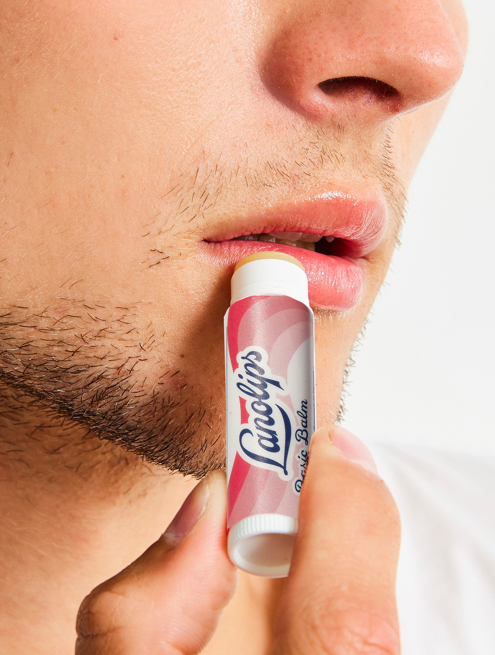 Lanolips Basic Balm Strawberry applied on model.