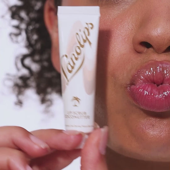 Video showcasing Lanolips Lip Scrubs in Coconutter and Strawberry. These 100% natural balm-based lip scrubs use gentle sugar and finely ground fruit to exfoliate dry lips. With 70% lanolin, they deeply hydrate and reveal soft, smooth lips with a healthy glow.