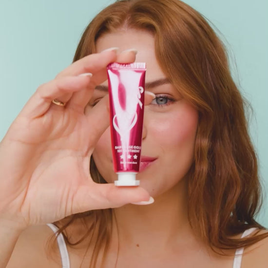 Video of a model applying and wearing Lanolips Baby Rose Gold 101 Ointment, revealing a dewy pink-flushed tint with soft rose gold pigments. The ultra-hydrating formula melts into the lips and cheeks, mimicking a natural, healthy flush. The lightweight, non-sticky balm enhances moisture while adding a luminous glow.