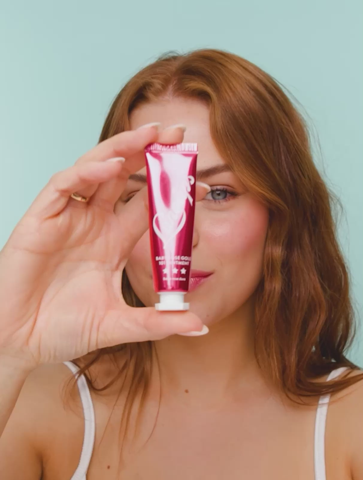 Video of a model applying and wearing Lanolips Baby Rose Gold 101 Ointment, revealing a dewy pink-flushed tint with soft rose gold pigments. The ultra-hydrating formula melts into the lips and cheeks, mimicking a natural, healthy flush. The lightweight, non-sticky balm enhances moisture while adding a luminous glow.