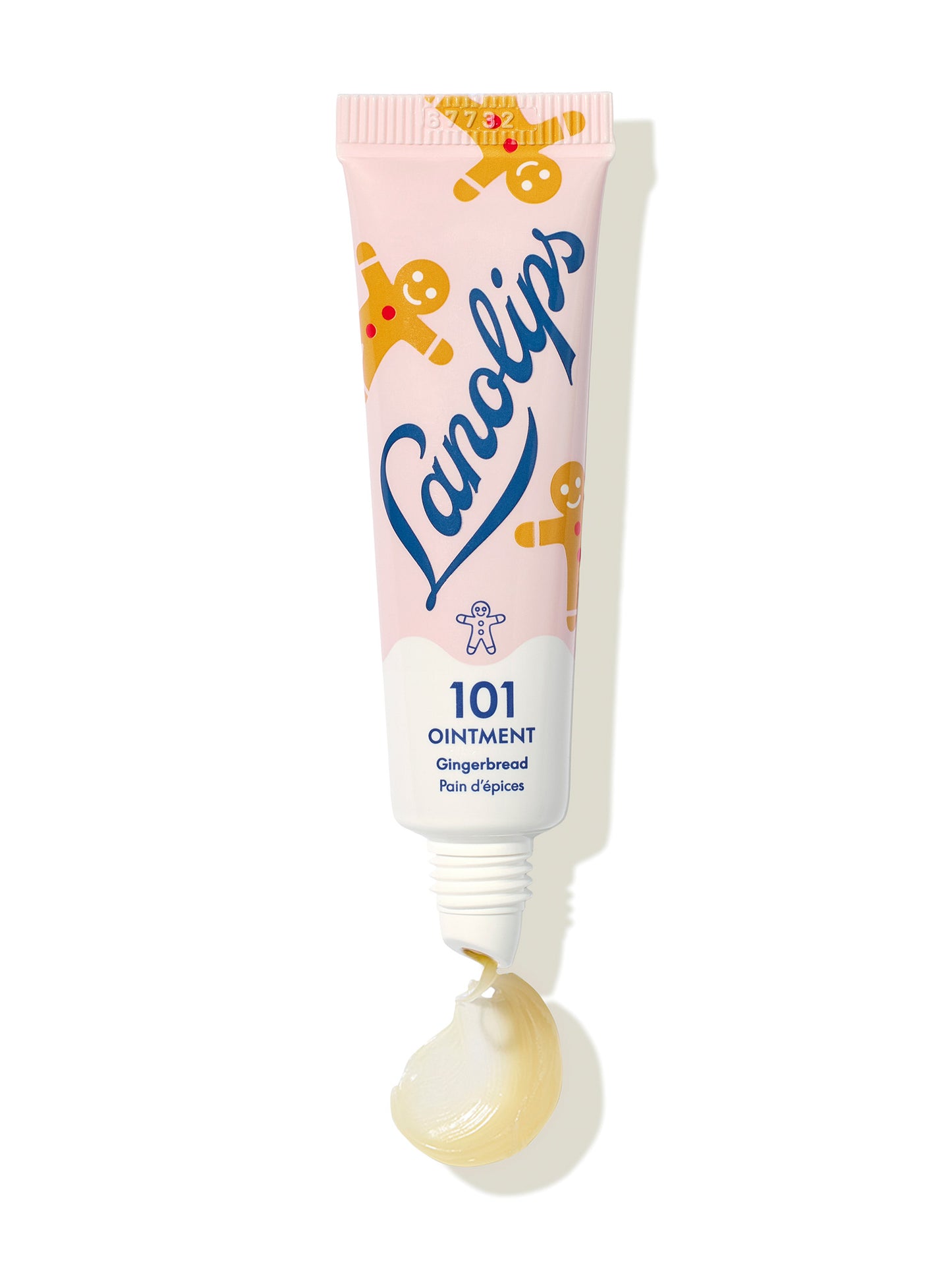 Squeezed shot of Lanolips 101 Ointment Multi-Balm Gingerbread tube with pink packaging on a white background. Hydrates dry lips, skin patches, cuticles, elbows & more. An all-natural lanolin with vitamin-e.